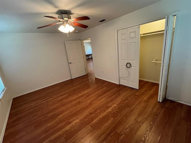 unfurnished bedroom with a closet, ceiling fan, and dark hardwood / wood-style flooring