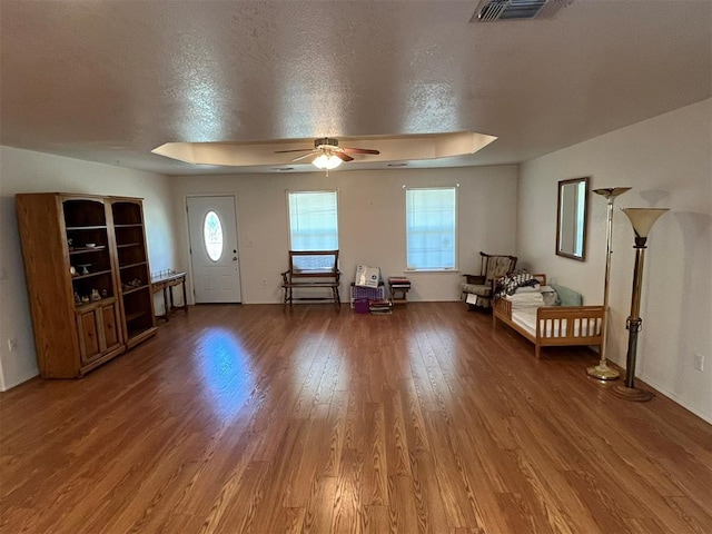 208 N Kay Dr, Broken Bow, OK 74728 - entrance foyer featuring wood finished floors, healthy amount of natural light, ceiling fan, and baseboards
