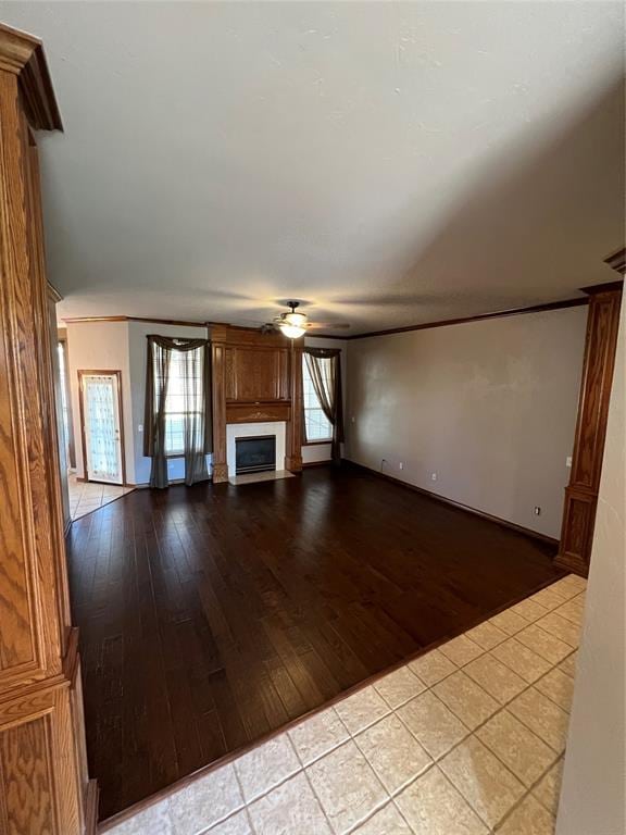 unfurnished living room featuring ceiling fan and light hardwood / wood-style floors