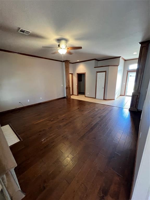 spare room featuring crown molding, ceiling fan, and dark wood-type flooring