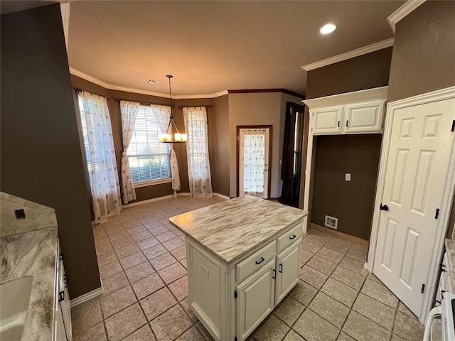 kitchen featuring crown molding, pendant lighting, a notable chandelier, white cabinets, and a center island