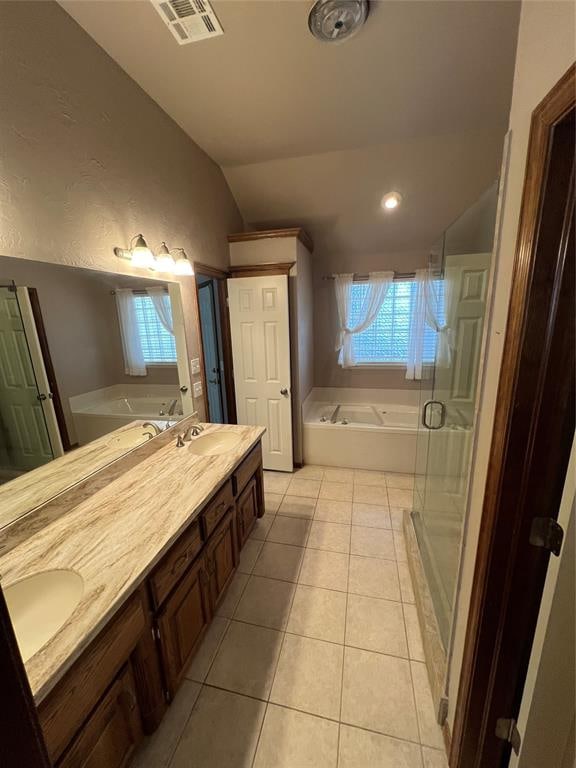 bathroom with tile patterned flooring, vanity, lofted ceiling, and shower with separate bathtub