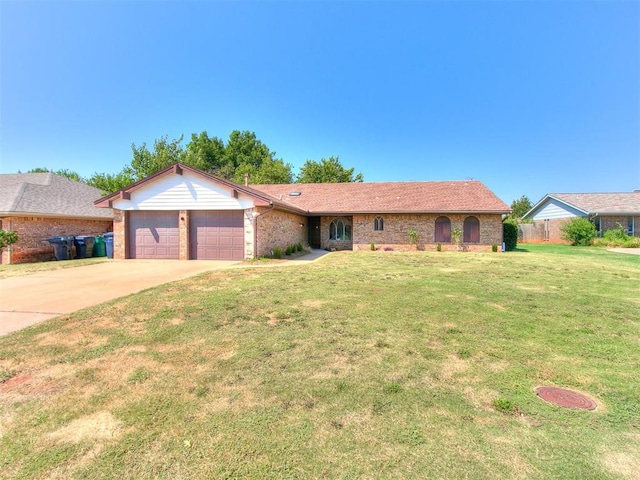 single story home featuring a garage and a front yard