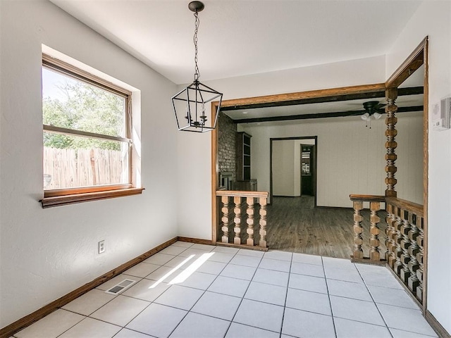 unfurnished dining area featuring hardwood / wood-style flooring and an inviting chandelier