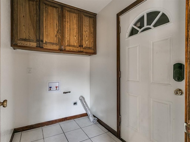 laundry room featuring hookup for an electric dryer, cabinets, light tile patterned floors, and hookup for a washing machine