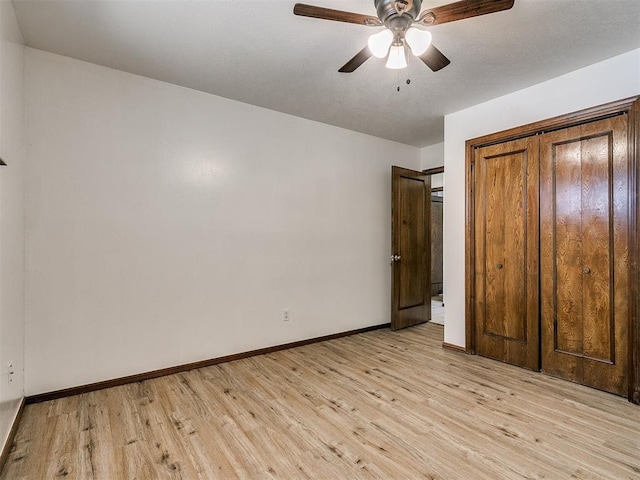 unfurnished bedroom featuring ceiling fan, light hardwood / wood-style floors, and a closet