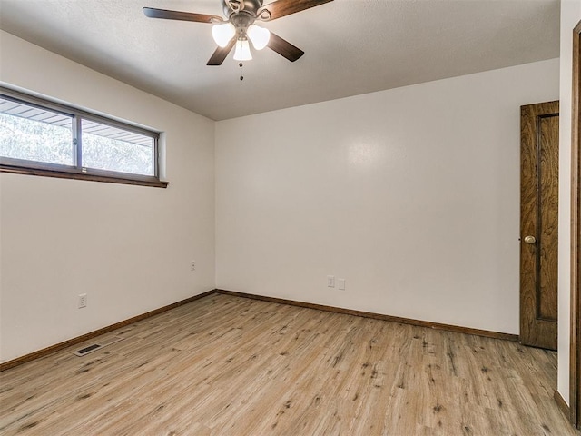 unfurnished room featuring light wood-type flooring and ceiling fan