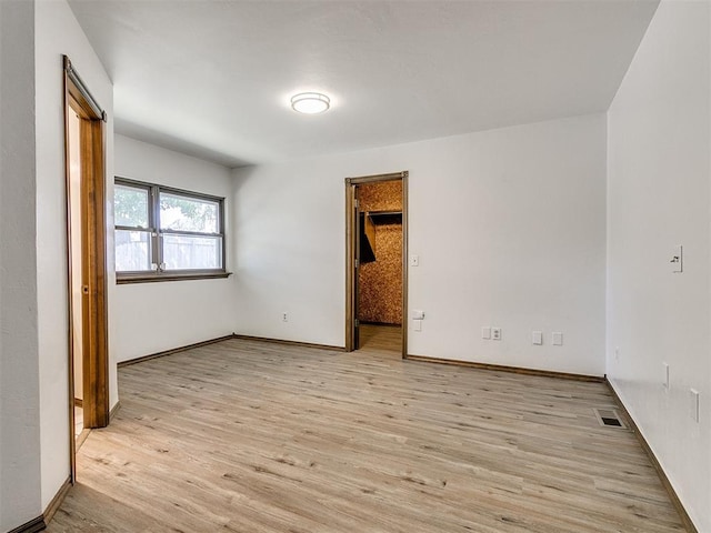 spare room featuring light hardwood / wood-style flooring