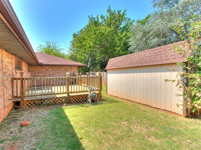 view of yard with a storage unit and a wooden deck