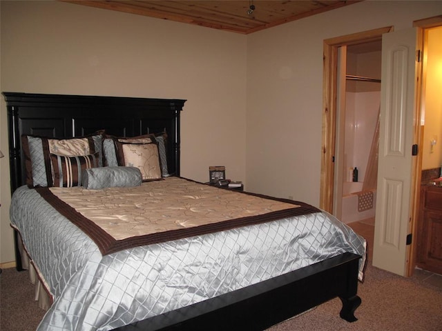 carpeted bedroom with a closet and wood ceiling