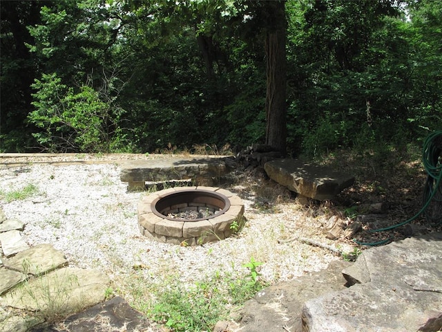 view of yard with an outdoor fire pit