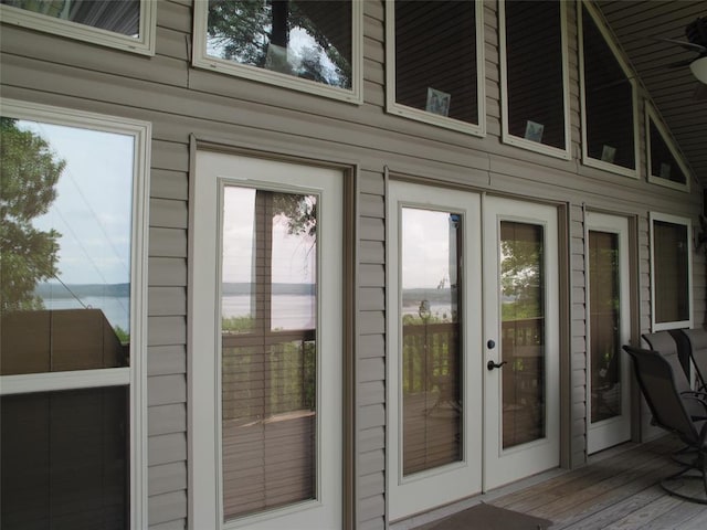 doorway to outside with hardwood / wood-style floors and wooden walls