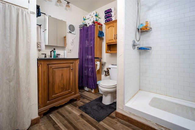 bathroom featuring hardwood / wood-style flooring, vanity, curtained shower, and toilet