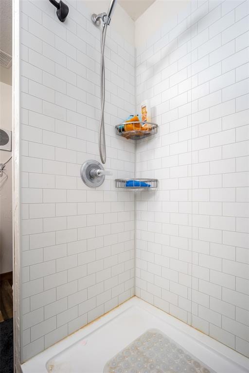 bathroom with tiled shower