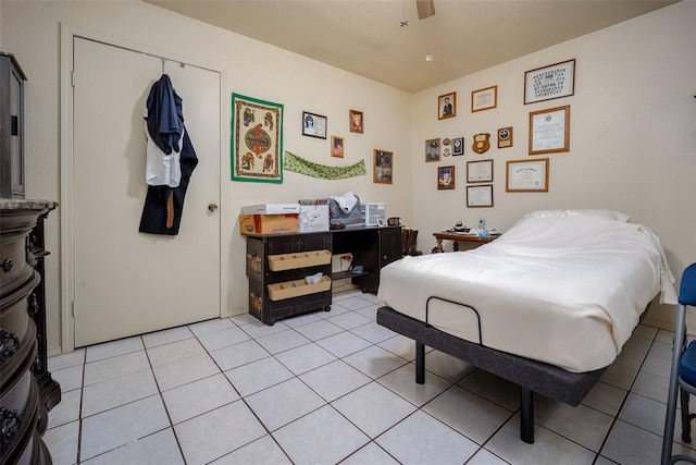 bedroom with ceiling fan, a closet, and light tile patterned flooring