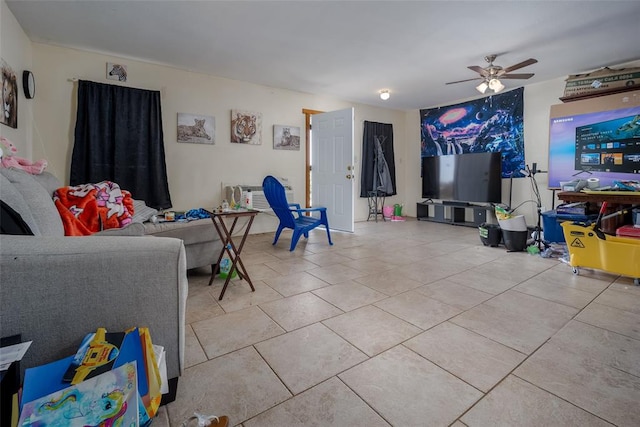 living room featuring ceiling fan, light tile patterned floors, and a wall mounted AC