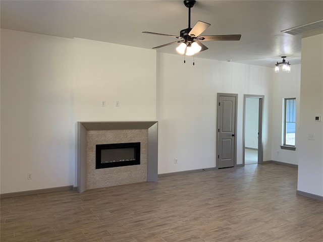 unfurnished living room with hardwood / wood-style flooring and ceiling fan