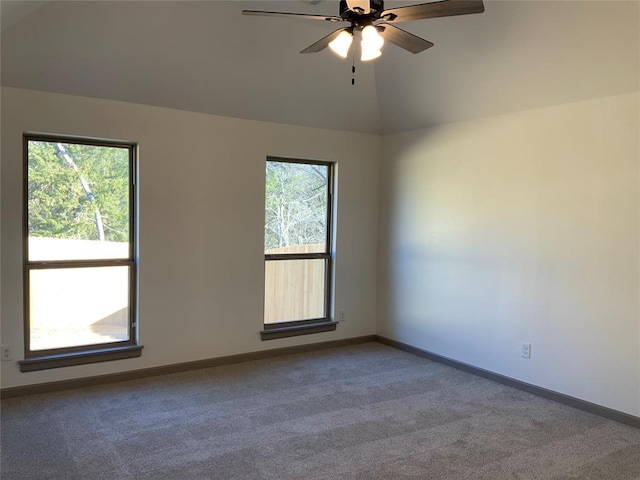 carpeted empty room featuring lofted ceiling and ceiling fan