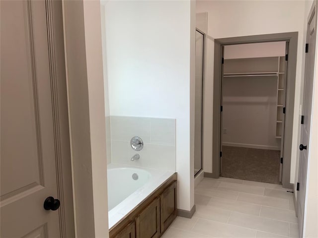 bathroom with tile patterned flooring and independent shower and bath