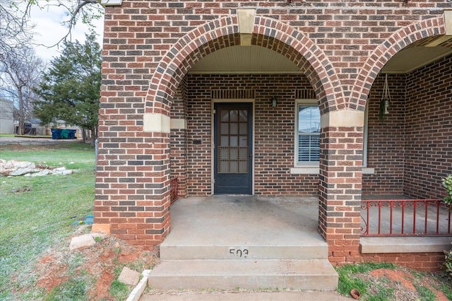 view of exterior entry with a porch