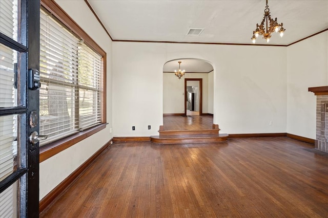 spare room featuring crown molding and dark wood-type flooring