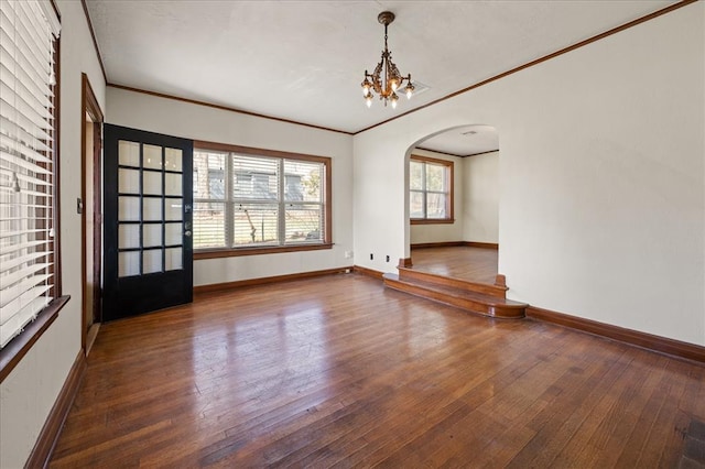 unfurnished dining area featuring hardwood / wood-style floors, ornamental molding, and a chandelier