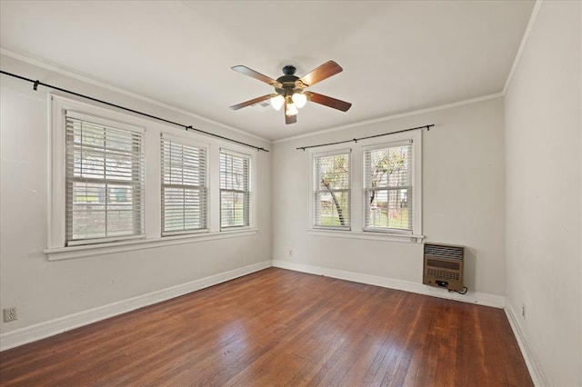 unfurnished room featuring ceiling fan, dark hardwood / wood-style flooring, crown molding, and heating unit