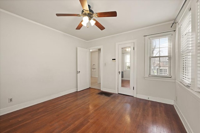 unfurnished bedroom with ceiling fan, dark hardwood / wood-style flooring, and crown molding