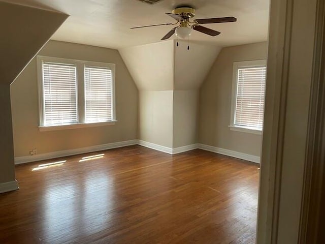 bonus room with hardwood / wood-style floors, a wealth of natural light, lofted ceiling, and ceiling fan