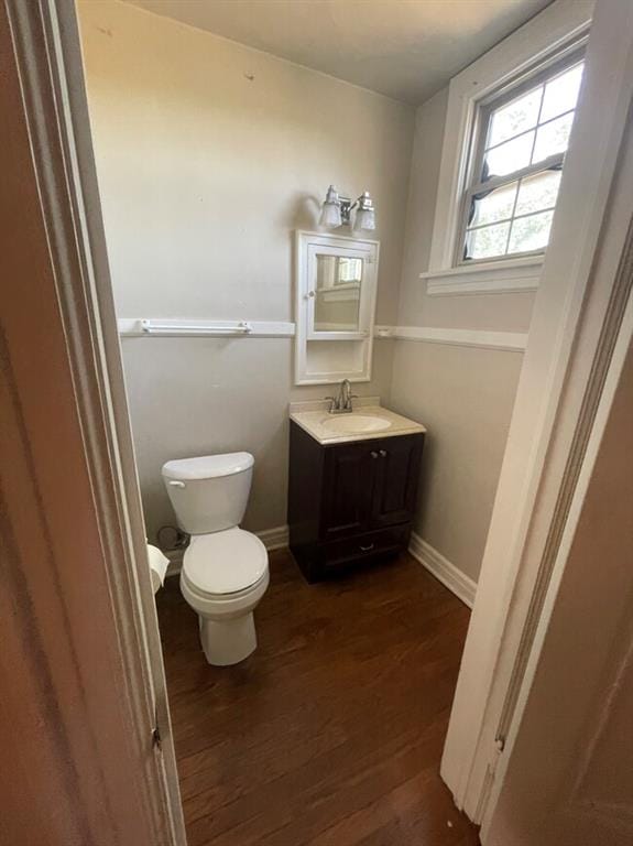 bathroom featuring hardwood / wood-style floors, vanity, and toilet