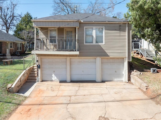 view of front facade with a garage and a balcony