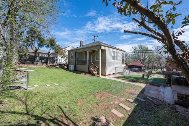 view of home's exterior featuring a porch and a yard