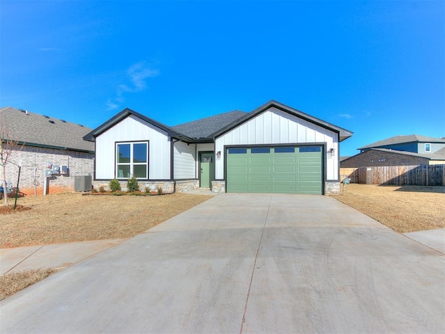 view of front of house featuring a garage and central air condition unit