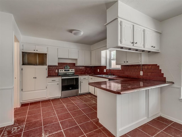 kitchen featuring kitchen peninsula, white cabinetry, sink, and stainless steel range with electric cooktop