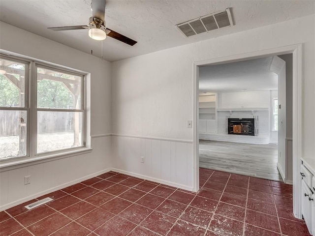 unfurnished room with ceiling fan