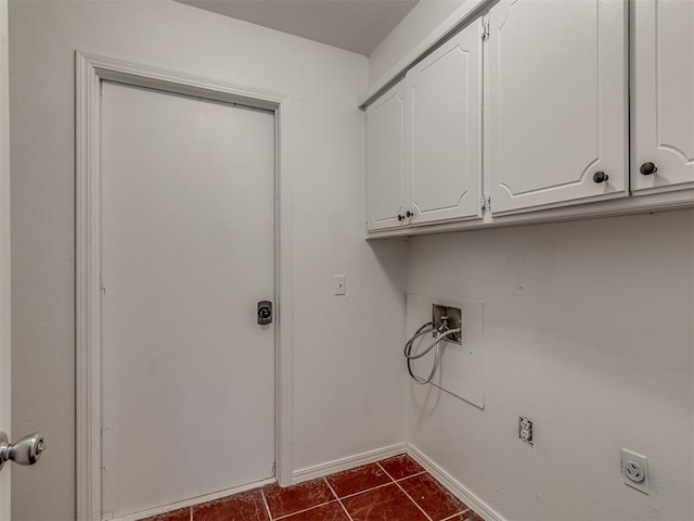 clothes washing area with cabinets, washer hookup, dark tile patterned floors, and electric dryer hookup