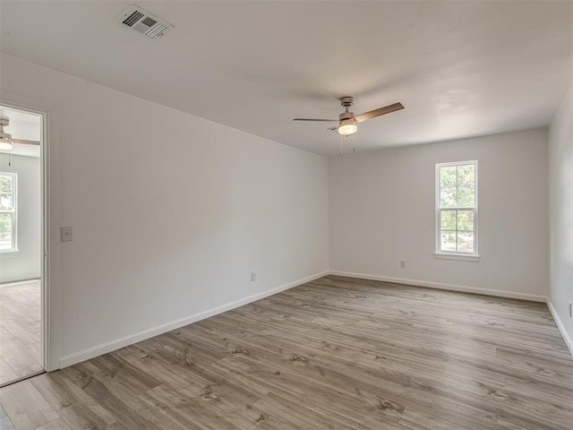 empty room featuring ceiling fan and light hardwood / wood-style flooring