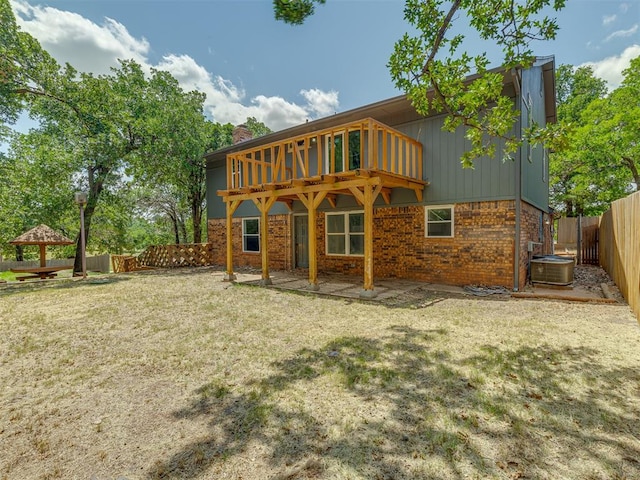 rear view of property featuring cooling unit