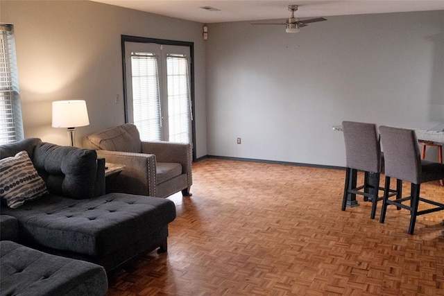 living room featuring parquet floors and ceiling fan