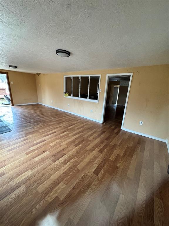 interior space featuring wood-type flooring and a textured ceiling