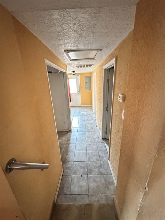 hall with tile patterned floors