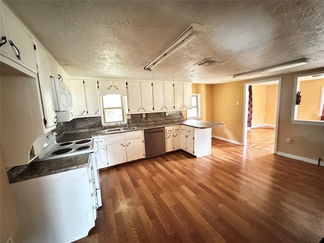 kitchen with white cabinets, a textured ceiling, white appliances, and dark hardwood / wood-style flooring