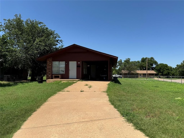 view of front of property with an outbuilding, a garage, and a front lawn