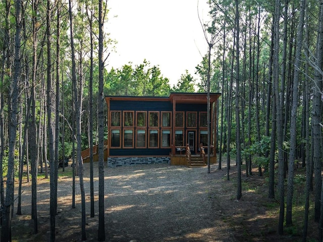 view of outdoor structure featuring a sunroom