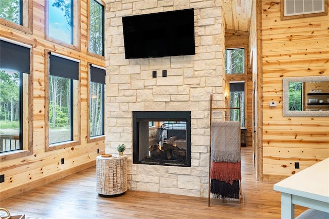 living room with a fireplace, wood-type flooring, and plenty of natural light