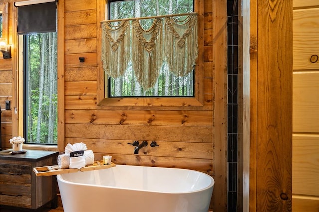 bathroom featuring a bathing tub and wooden walls