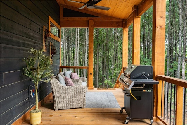 sunroom featuring vaulted ceiling, ceiling fan, and wooden ceiling