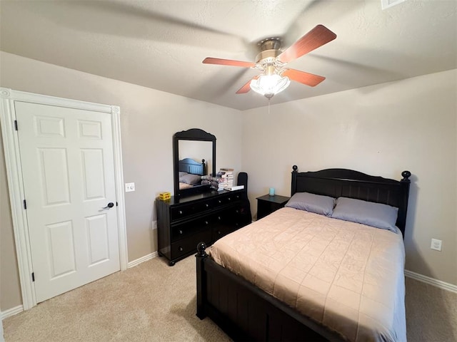 carpeted bedroom with ceiling fan