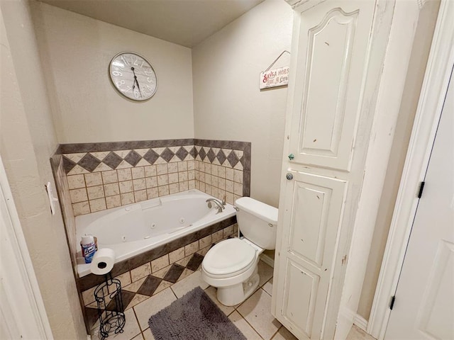 bathroom with tile patterned floors, tiled bath, and toilet