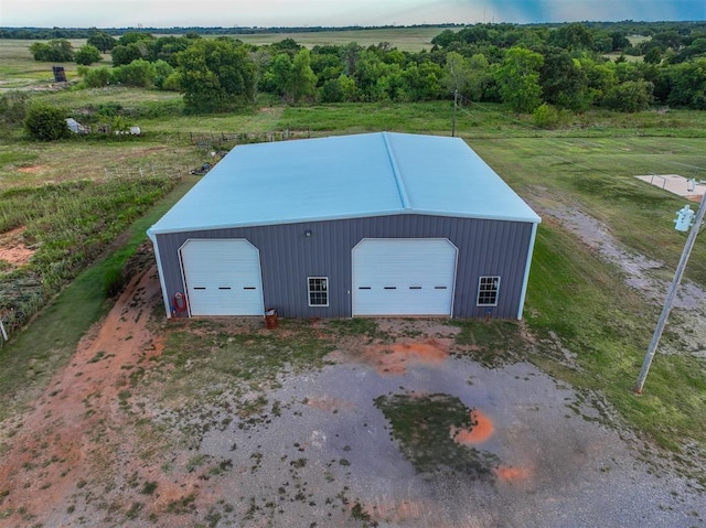 view of outdoor structure with a rural view and a garage